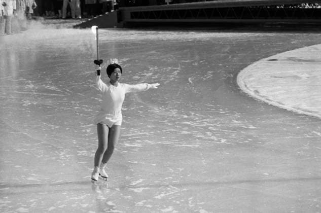 Sapporo, Japan. February 3, 1972. Japanese figure skater Izumi Tsujimura skates with the Olympic Flame at the Makomanai Stadium during the opening ceremony of the 1972 Winter Olympics. Viktor Budan TASS  17525960