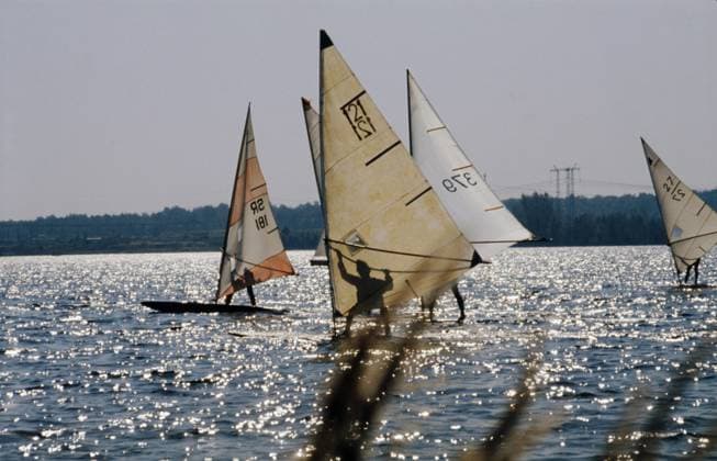 September, 1976. Moscow Region, USSR. Sportsmen take part in the windsurfing competition on Klyazma Reservoir of Moscow Canal. The exact date of the photograph is unknown. Boris Klinchenko TASS  18579492