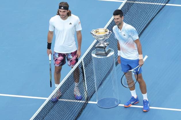 (230129) -- MELBOURNE, Jan. 29, 2023 -- Novak Djokovic (R) of Serbia and Stefanos Tsitsipas of Greece pose with the trophy prior to the men s singles final match at Australian Open tennis tournament, in Melbourne, Australia, Jan. 29, 2023. ) (SP)AUSTRALIA-MELBOURNE-TENNIS-AUSTRALIAN OPEN-MEN S SINGLES-FINAL BaixXuefei 