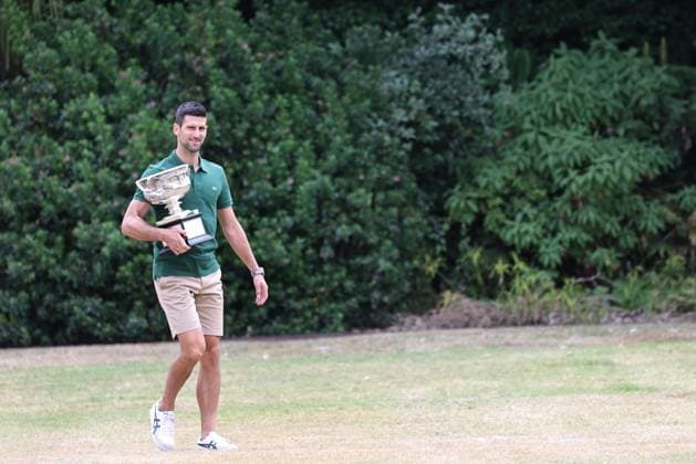 Novak Djokovic, SRB, presenting his trophy in the governmental house gardens after the 2023 Australian Open in Melbourne, 30 01 2023