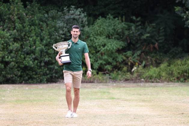 Novak Djokovic, SRB, presenting his trophy in the governmental house gardens after the 2023 Australian Open in Melbourne, 30 01 2023