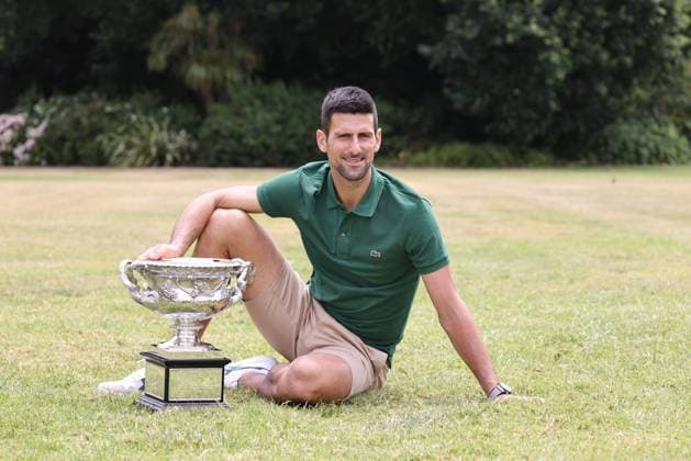 Novak Djokovic, SRB, presenting his trophy in the governmental house gardens after the 2023 Australian Open in Melbourne, 30 01 2023