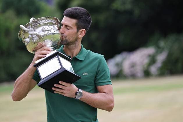 Novak Djokovic, SRB, presenting his trophy in the governmental house gardens after the 2023 Australian Open in Melbourne, 30 01 2023