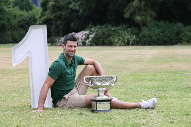 Novak Djokovic, SRB, presenting his trophy in the governmental house gardens after the 2023 Australian Open in Melbourne, 30 01 2023