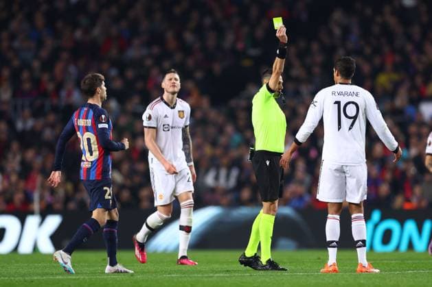 Mandatory Credit: Photo by Simon Dael Shutterstock (13765759u) Raphael Varane of Manchester United, ManU is shown a yellow card Barcelona v Manchester United, UEFA Europa League, Play-Off Round, First Leg, Football, Camp Nou, Barcelona, Spain - 16 Feb 2023 EDITORIAL USE ONLY No use with unauthorised audio, video, data, fixture lists, club league logos or live services. Online in-match use limited to 120 images, no video emulation. No use in betting, games or single club league player publications. Barcelona v Manchester United, UEFA Europa League, Play-Off Round, First Leg, Football, Camp Nou, Barcelona, Spain - 16 Feb 2023 EDITORIAL USE ONLY No use with unauthorised audio, video, data, fixture lists, club league logos or live services. Online in-match use limited to 120 images, no video emulation. No use in betting, games or single club league player publications. Copyright: xSimonxDael Shutterstockx 13765759u
