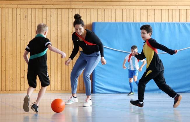 BAU 21 02 2023 Stuttgart Untertürkheim soccer media appointment UEFO Euro 2024 with tournament director Philipp Lahm and ambassador Celia Sasic, Celia Sasic left plays soccer with children