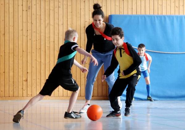 BAU 21 02 2023 Stuttgart Untertürkheim soccer media appointment UEFO Euro 2024 with tournament director Philipp Lahm and ambassador Celia Sasic, Celia Sasic left plays soccer with children