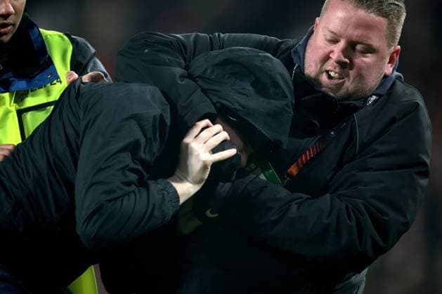 EINDHOVEN - A supporter is taken off the pitch during the UEFA Europa league play-off match between PSV Eindhoven and Sevilla FC at Phillips stadium on February 23, 2023 in Eindhoven, Netherlands. AP Dutch Height Jeroen Putmans PSV Eindhoven v Sevilla FC: Knockout Round Play-Off Leg Two - UEFA Europa League 2022 2023 xVIxANPxSportx xJeroenxPutmansxIVx 463453568 originalFilename: 463453568.jpg