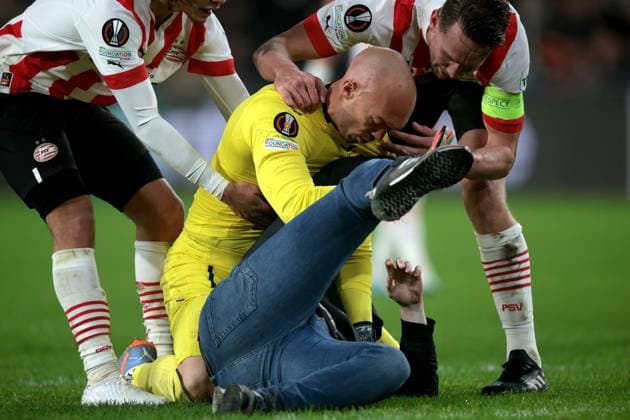 EINDHOVEN - A supporter fights with Sevilla FC goalkeeper Marko Dmitrovic during the UEFA Europa league play-off match between PSV Eindhoven and Sevilla FC at Phillips stadium on February 23, 2023 in Eindhoven, Netherlands. AP Dutch Height Jeroen Putmans PSV Eindhoven v Sevilla FC: Knockout Round Play-Off Leg Two - UEFA Europa League 2022 2023 xVIxANPxSportx xJeroenxPutmansxIVx 463454265 originalFilename: 463454265.jpg