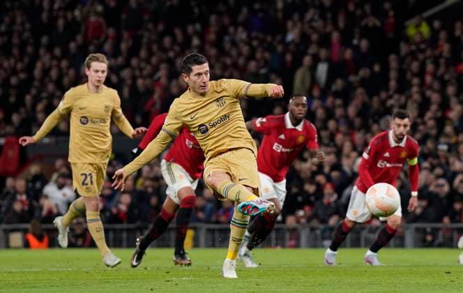 Manchester, England, 23rd February 2023. Robert Lewandowski of Barcelona scores from the penalty spot during the UEFA Europa League match at Old Trafford, Manchester. Picture credit should read: Andrew Yates Sportimage EDITORIAL USE ONLY. No use with unauthorised audio, video, data, fixture lists, club league logos or live services. Online in-match use limited to 120 images, no video emulation. No use in betting, games or single club league player publications. SPI-2256-0037