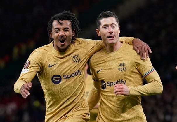Manchester, England, 23rd February 2023. Robert Lewandowski of Barcelona (r0 celebrates scoring the first goal with ˜Jules Kounde of Barcelona (l) during the UEFA Europa League match at Old Trafford, Manchester. Picture credit should read: Andrew Yates Sportimage EDITORIAL USE ONLY. No use with unauthorised audio, video, data, fixture lists, club league logos or live services. Online in-match use limited to 120 images, no video emulation. No use in betting, games or single club league player publications. SPI-2256-0043