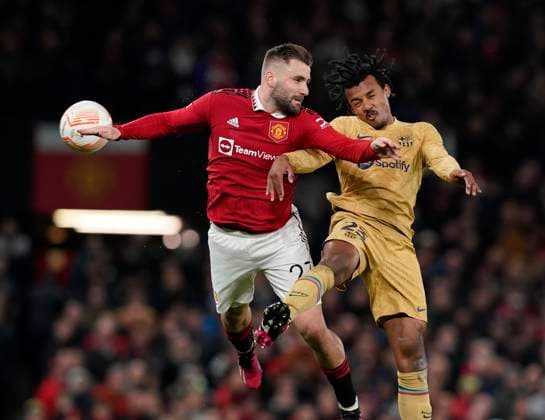Manchester, England, 23rd February 2023. Luke Shaw of Manchester United, ManU challenges Jules Kounde of Barcelona during the UEFA Europa League match at Old Trafford, Manchester. Picture credit should read: Andrew Yates Sportimage EDITORIAL USE ONLY. No use with unauthorised audio, video, data, fixture lists, club league logos or live services. Online in-match use limited to 120 images, no video emulation. No use in betting, games or single club league player publications. SPI-2256-0055