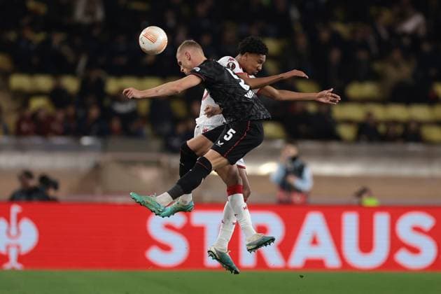 Monaco, Monaco, 23rd February 2023. Mitchel Bakker of Bayer Leverkusen challenges Edan Diop of AS Monaco for an aerial ball the UEFA Europa League match at Stade Louis II, Monaco. Picture credit should read: Jonathan Moscrop Sportimage EDITORIAL USE ONLY. No use with unauthorised audio, video, data, fixture lists, club league logos or live services. Online in-match use limited to 120 images, no video emulation. No use in betting, games or single club league player publications. SPI-2233-0048