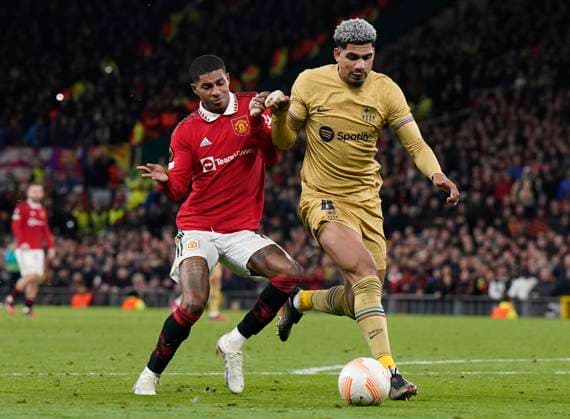 Manchester, England, 23rd February 2023. Ronald Araujo of Barcelona tussles with Marcus Rashford of Manchester United, ManU during the UEFA Europa League match at Old Trafford, Manchester. Picture credit should read: Andrew Yates Sportimage EDITORIAL USE ONLY. No use with unauthorised audio, video, data, fixture lists, club league logos or live services. Online in-match use limited to 120 images, no video emulation. No use in betting, games or single club league player publications. SPI-2256-0098