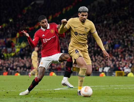 Manchester, England, 23rd February 2023. Ronald Araujo of Barcelona tussles with Marcus Rashford of Manchester United, ManU during the UEFA Europa League match at Old Trafford, Manchester. Picture credit should read: Andrew Yates Sportimage EDITORIAL USE ONLY. No use with unauthorised audio, video, data, fixture lists, club league logos or live services. Online in-match use limited to 120 images, no video emulation. No use in betting, games or single club league player publications. SPI-2256-0099