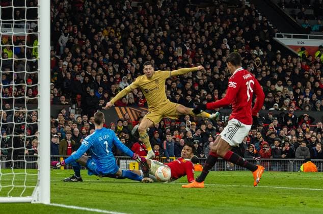 Football - UEFA Europa League - Play-Off 2nd Leg - Manchester United, ManU FC v FC Barcelona, Barca MANCHESTER, ENGLAND - Thursday, February 23, 2023: Manchester United s RaphaÃ«l Varane clears the ball after a shot from Barcelona s Robert Lewandowski during the UEFA Europa League Play-Off 2nd Leg game between Manchester United FC and FC Barcelona at Old Trafford. MANCHESTER Old Trafford GREATER MANCHESTER ENGLAND  Copyright: xDavidxRawcliffex P2023-02-23-Man_Utd_Barcelona-90