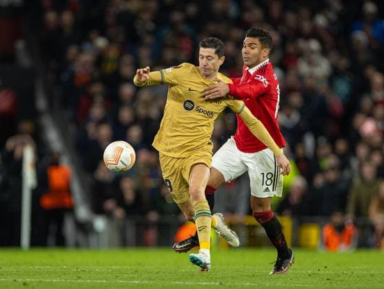 Football - UEFA Europa League - Play-Off 2nd Leg - Manchester United, ManU FC v FC Barcelona, Barca MANCHESTER, ENGLAND - Thursday, February 23, 2023: Barcelona s Robert Lewandowski (L) is brought down by Manchester United s Carlos Henrique Casimiro during the UEFA Europa League Play-Off 2nd Leg game between Manchester United FC and FC Barcelona at Old Trafford. MANCHESTER Old Trafford GREATER MANCHESTER ENGLAND  Copyright: xDavidxRawcliffex P2023-02-23-Man_Utd_Barcelona-95