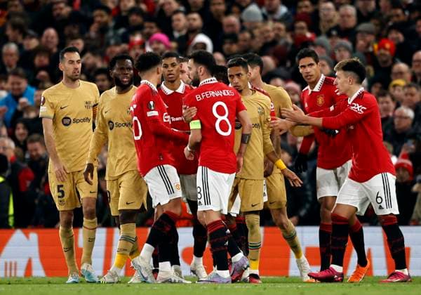 Football - 2022 2023 UEFA Europa League - Play-Off - Second Leg - Manchester United, ManU vs Barcelona - Old Trafford - Thursday 23rd February 2023 Barcelona players gather around Bruno Fernandes of Manchester United after a foul on team mate Frenkie de Jong, at Old Trafford. 