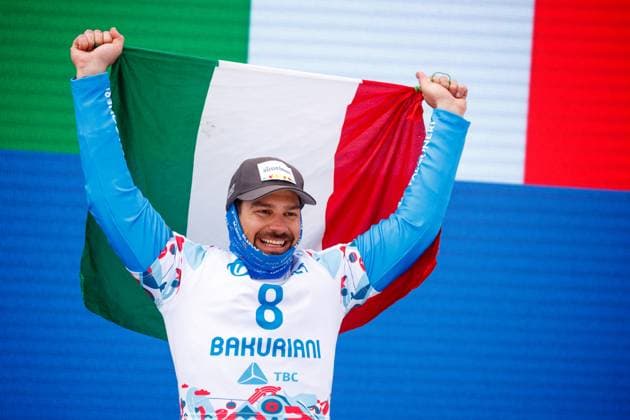 SNOWBOARD - FIS SX and SB World Championships Bakuriani 2023 BAKURIANI,GEORGIA,01.MAR.23 - SNOWBOARD - FIS Freestyle Ski and Snowboard World Championships, SBX, Snowboard Cross, ladies, men, award ceremony. Image shows the rejoicing of Omar Visintin (ITA). Keywords: flag.  GEPAxpictures xMaticxKlansek