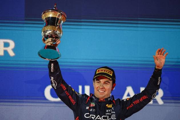 PEREZ Sergio (mex), Red Bull Racing RB19, portrait celebrates with the trophy at the podium during the Formula 1 Gulf Air Bahrain Grand Prix 2023, 1st round of the 2023 FIA Formula One World Championship, WM, Weltmeisterschaft from March 2 to 5, 2023 on the Bahrain International Circuit, in Sakhir, Bahrain - F1 - BAHRAIN GRAND PRIX 2023 - RACE DPPI Panoramic  00123003__R3_2143