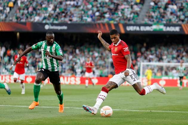 March 16, 2023, Seville, Spain: MARCUS RASHFORD of Manchester United, ManU (R) shoots in front of YOUSSOUF SABALY of Betis (L) during the Europa League Round of 16 (2st leg) soccer match between Real Betis and Manchester United at the Ramon Sanchez Pizjuan Stadium Seville Spain - ZUMAa142 20230316_zap_a142_011 Copyright: xDanielxGonzalezxAcunax