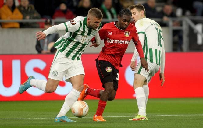 16.03.2023 Budapest(Hungary) Ferencvarosi TC-Bayer 04 Leverkusen Europa League round of 16 men s football Jeremie Frimpong(C) Bayer 04 Leverkusen between Eldar Civic(L),Kristoffer Zachariassen(R) Ferencvarosi TC :