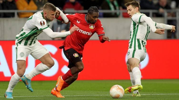 16.03.2023 Budapest(Hungary) Ferencvarosi TC-Bayer 04 Leverkusen Europa League round of 16 men s football Jeremie Frimpong(C) Bayer 04 Leverkusen between Eldar Civic(L),Kristoffer Zachariassen(R) Ferencvarosi TC :