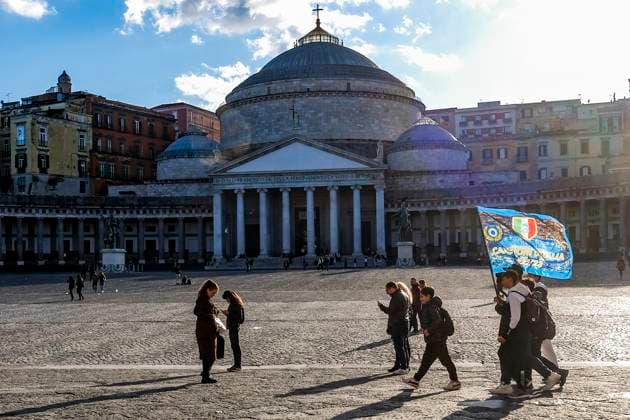 Boys walk in the main square of Naples Piazza del Plebiscito holding a Napoli flag with effigy of the scudetto (the symbol with the colors of the Italian flag that is affixed to the jersey of the team that wins the Italian Serie A soccer championship) are displayed in downtown. Preparations are in full swing in the city to celebrate the final victory of SSC Napoli, which leads the Italian championship with a 19-point lead with 11 games to go ABPH9217 Copyright: xAntonioxBalascox