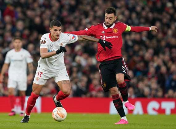 Manchester, England, 13th April 2023. Erik Lamela of Sevilla tussles with Bruno Fernandes of Manchester United, ManU during the UEFA Europa League match at Old Trafford, Manchester. Picture credit should read: Andrew Yates Sportimage EDITORIAL USE ONLY. No use with unauthorised audio, video, data, fixture lists, club league logos or live services. Online in-match use limited to 120 images, no video emulation. No use in betting, games or single club league player publications. SPI-2367-0023