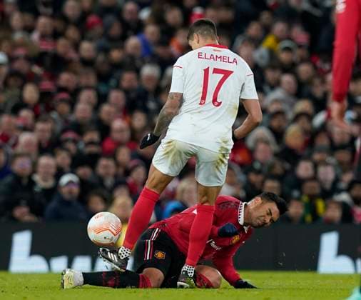 Manchester, England, 13th April 2023. Erik Lamela of Sevilla fouls Casemiro of Manchester United, ManU during the UEFA Europa League match at Old Trafford, Manchester. Picture credit should read: Andrew Yates Sportimage EDITORIAL USE ONLY. No use with unauthorised audio, video, data, fixture lists, club league logos or live services. Online in-match use limited to 120 images, no video emulation. No use in betting, games or single club league player publications. SPI-2367-0038