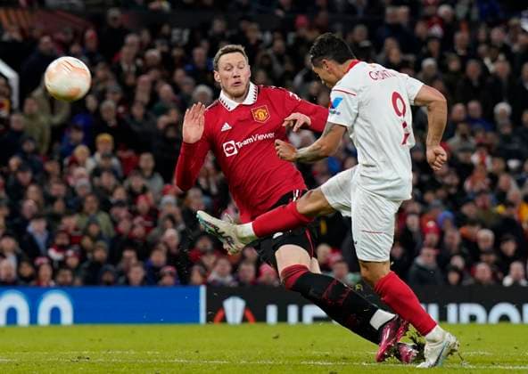Manchester, England, 13th April 2023. Gonzalo Montiel of Sevilla charged down by Wout Weghorst of Manchester United, ManU during the UEFA Europa League match at Old Trafford, Manchester. Picture credit should read: Andrew Yates Sportimage EDITORIAL USE ONLY. No use with unauthorised audio, video, data, fixture lists, club league logos or live services. Online in-match use limited to 120 images, no video emulation. No use in betting, games or single club league player publications. SPI-2367-0065