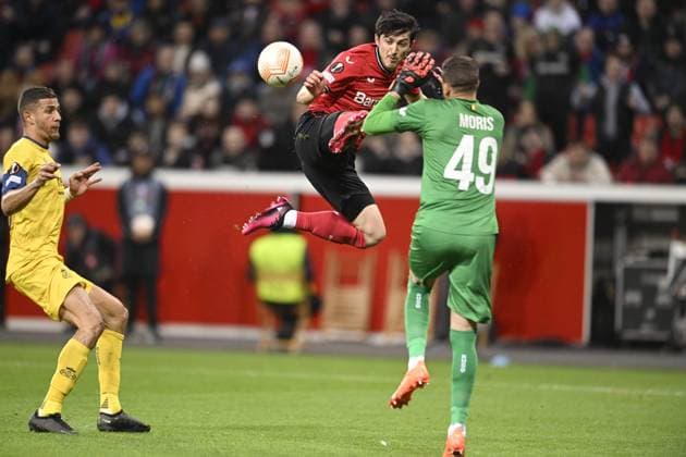 LEVERKUSEN, GERMANY - APRIL 13 : Azmoun Sardar forward of Bayer Leverkusen battles for the ball with Moris Anthony goalkeeper of Union St-Gilloise during the UEFA Europa League Quarter-finals, 1st leg match between Leverkusen and Union SG at the BayArena on April 13, 2023 in Leverkusen, Germany, 13 04 2023 ( Leverkusen v Union SG - UEFA Europa League PhotoNews Panoramic 