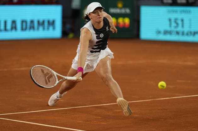 Iga Swiatek of Poland returns a shot to Petra Martic of Croatia during their quarter final match on day 8 of the Mutua Madrid Open at the Caja Magica stadium, in Madrid, Spain, on Wednesday, May 3, 2023.  PDH20230503102 PaulxHanna