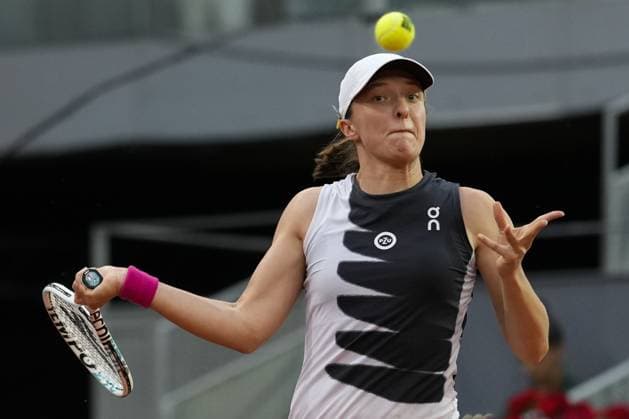 Iga Swiatek of Poland returns a shot to Petra Martic of Croatia during their quarter final match on day 8 of the Mutua Madrid Open at the Caja Magica stadium, in Madrid, Spain, on Wednesday, May 3, 2023.  PDH20230503110 PaulxHanna