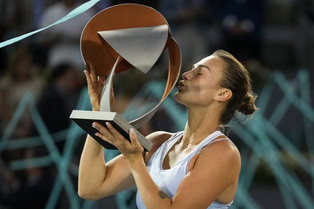 Aryna Sabalenka of Belarus kisses her trophy on the podium after winning the 2023 Mutua Madrid Open against Iga Swiatek of Poland at the Caja Magica stadium, in Madrid, Spain, on Saturday, May 6, 2023.  PDH20230506012 PaulxHanna