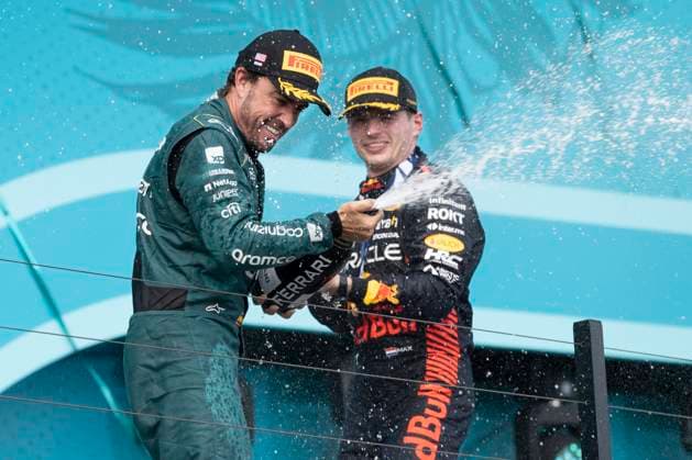 May 7, 2023, Miami, Florida, United States: FERNANDO ALONSO (SPA) of Aston Martin 14 celebrates finishing P3 on the podium (left) along with winner MAX VERSTAPPEN (NED) of Red Bull Racing 1 (right)..Max Verstappen won the Formula 1 Crypto.com Miami Grand Prix after besting teammate Sergio Perez, who finished second. Fernando Alonso of Aston Martin made the podium, finishing P3...Red Bull Oracle Racing s Max Verstappen maintains his dominance over the 2023 season. Motorsports, open wheel racing, Liberty Media, F1. Miami United States - ZUMAb177 20230507_zap_b177_048 Copyright: xTaidghxBarronx
