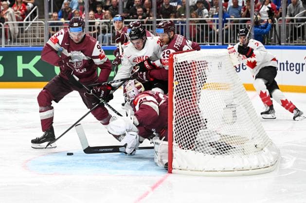 RIGA, LATVIA MAY 12 Jack Quinn of Canada fights for the puck against Oskars Batna of Latvia L , Ralfs Freibergs of Latvia R and goalkeeper Ivars Punnenovs of Latvia during the 2023 IIHF Ice Hockey World Championship Finland game between Latvia and Canada at Arena Riga on May 12, 2023 in Riga, Latvia Riga Arena Riga Latvia  Copyright: xJustPictures.ch AndreaxBrancax