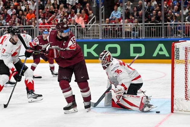 RIGA, LATVIA MAY 12 Kaspars Daugavins of Latvia tries to deflect the puck against goalkeeper Samuel Montembeault of Canada during the 2023 IIHF Ice Hockey World Championship Finland Latvia game between Latvia and Canada at Arena Riga on May 12, 2023 in Riga, Latvia Riga Arena Riga Latvia  Copyright: xJustPictures.ch AndreaxBrancax
