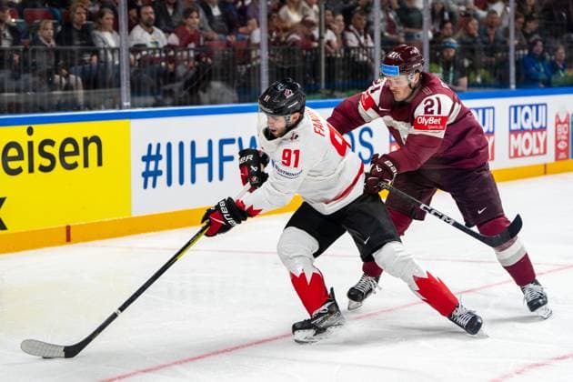 RIGA, LATVIA MAY 12 Adam Fantilli of Canada L against Rudolfs Balcers of Latvia R during the 2023 IIHF Ice Hockey World Championship Finland Latvia game between Latvia and Canada at Arena Riga on May 12, 2023 in Riga, Latvia Riga Arena Riga Latvia  Copyright: xJustPictures.ch JarixPestelaccix