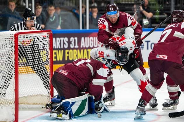 RIGA, LATVIA MAY 12 Andris Dzerins of Latvia C behind defending goalkeeper Arturs Silovs of Latvia L from Joe Veleno of Canada C in front during the 2023 IIHF Ice Hockey World Championship Finland Latvia game between Latvia and Canada at Arena Riga on May 12, 2023 in Riga, Latvia Riga Arena Riga Latvia  Copyright: xJustPictures.ch JarixPestelaccix
