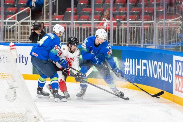 RIGA, LATVIA MAY 14 Kristjan Cepon of Slovenia R held by Aleksandar Magovac of Slovenia L to defend the puck from Michael Carcone of Canada C during the 2023 IIHF Ice Hockey World Championship Finland Latvia game between Slovenia and Canada at Arena Riga on May 14, 2023 in Riga, Latvia Riga Arena Riga Latvia  Copyright: xJustPictures.ch JarixPestelaccix
