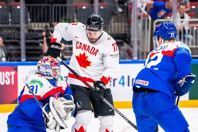 RIGA, LATVIA MAY 15 Milan Lucic of Canada C deflect the puck in from of Samuel Hlavaj of Slovakia L during the 2023 IIHF Ice Hockey World Championship Finland Latvia game between Slovakia and Canada at Arena Riga on May 15, 2023 in Riga, Latvia Riga Arena Riga Latvia  Copyright: xJustPictures.ch JarixPestelaccix