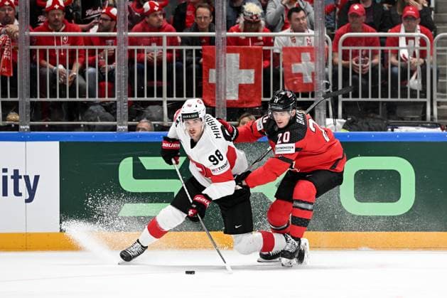 RIGA, LATVIA MAY 20 Marco Miranda of Switzerland battles for the puck possession against Justin Barron of Canada during the 2023 IIHF Ice Hockey World Championship Finland Latvia game between Canada Switzerland at Arena Riga on May 20, 2023 in Riga, Latvia Riga Arena Riga Latvia  Copyright: xJustPictures.ch AndreaxBrancax