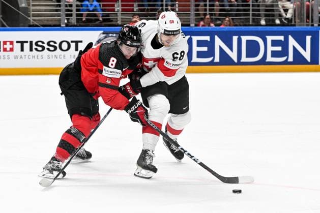 RIGA, LATVIA MAY 20 Fabrice Herzog of Switzerland and Cody Glass of Canada battle for the puck during the 2023 IIHF Ice Hockey World Championship Finland Latvia game between Canada Switzerland at Arena Riga on May 20, 2023 in Riga, Latvia Riga Arena Riga Latvia  Copyright: xJustPictures.ch AndreaxBrancax