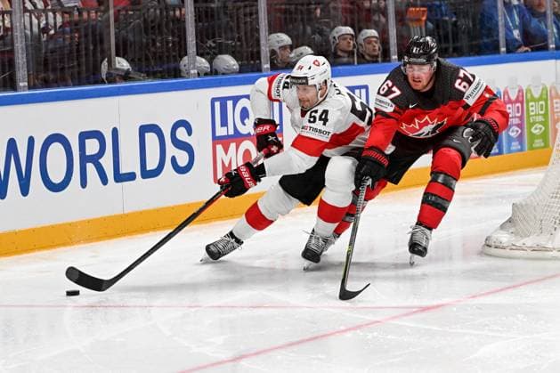 RIGA, LATVIA MAY 20 Christian Marti of Switzerland protects the puck against Lawson Crouse of Canada during the 2023 IIHF Ice Hockey World Championship Finland Latvia game between Canada Switzerland at Arena Riga on May 20, 2023 in Riga, Latvia Riga Arena Riga Latvia  Copyright: xJustPictures.ch AndreaxBrancax
