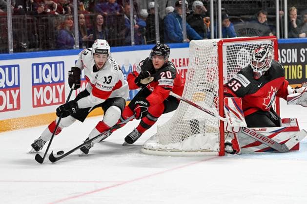 RIGA, LATVIA MAY 20 Nico Hischier of Switzerland in action against Justin Barron of Canada and goalkeeper Samuel Montembeault of Canada during the 2023 IIHF Ice Hockey World Championship Finland Latvia game between Canada Switzerland at Arena Riga on May 20, 2023 in Riga, Latvia Riga Arena Riga Latvia  Copyright: xJustPictures.ch AndreaxBrancax