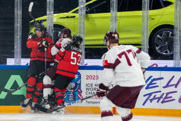 RIGA, LATVIA MAY 27 Uvis Janis Balinskis of Latvia 2nd from L closed between Jack Mcbain of Canada L and Michael Carcone of Canada C during the 2023 IIHF Ice Hockey World Championship Finland Latvia game between Canada and Latvia at Nokia Arena on May 27, 2023 in Tampere, Finland Tampere Finland  Copyright: xJustPictures.ch JarixPestelaccix