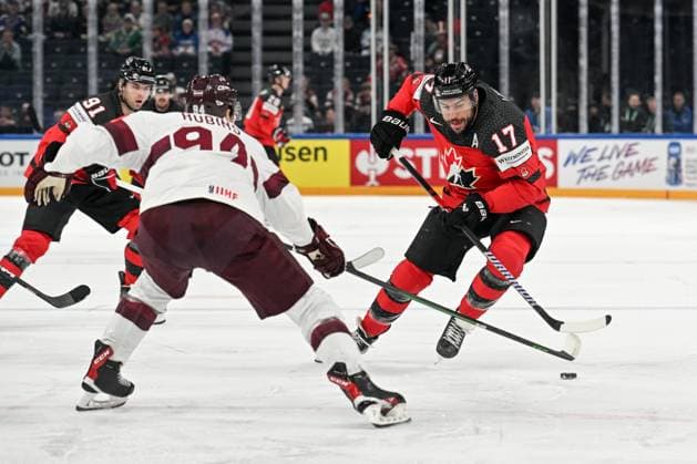 RIGA, LATVIA MAY 27 Milan Lucic of Canada enters the offensive zone against Kristians Rubins of Latvia during the 2023 IIHF Ice Hockey World Championship Finland game between Canada and Latvia at Nokia Arena on May 27, 2023 in Tampere, Finland Tampere Finland  Copyright: xJustPictures.ch AndreaxBrancax