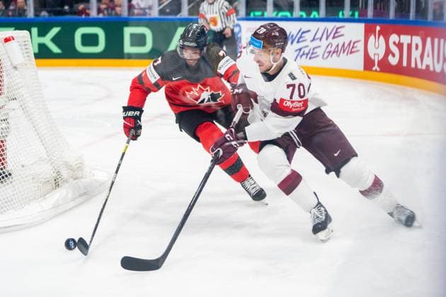 RIGA, LATVIA MAY 27 Miks Indrasis of Latvia R chased by Pierre Olivier Joseph of Canada L during the 2023 IIHF Ice Hockey World Championship Finland Latvia game between Canada and Latvia at Nokia Arena on May 27, 2023 in Tampere, Finland Tampere Finland  Copyright: xJustPictures.ch JarixPestelaccix