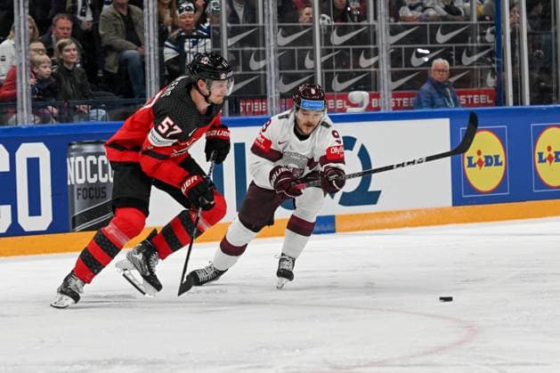 RIGA, LATVIA MAY 27 Renars Krastenbergs of Latvia fights for the puck against Tyler Myers of Canada during the 2023 IIHF Ice Hockey World Championship Finland Latvia game between Canada and Latvia at Nokia Arena on May 27, 2023 in Tampere, Finland Tampere Finland  Copyright: xJustPictures.ch AndreaxBrancax